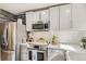 Modern kitchen with stainless steel appliances and white countertop at 6069 S Marshall Dr, Littleton, CO 80123