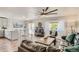 Open concept living room featuring hardwood floors, a kitchen, and natural lighting at 6069 S Marshall Dr, Littleton, CO 80123