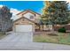 Charming two-story home featuring a stone facade and well-maintained front yard with mature trees at 7211 Wiltshire Ct, Highlands Ranch, CO 80130