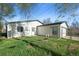 View of the house's back exterior with a small yard and white siding at 3025 Ivanhoe St, Denver, CO 80207