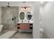 Modern bathroom featuring dual sinks, backlit mirrors, luxurious shower, and modern fixtures at 3025 Ivanhoe St, Denver, CO 80207