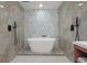 Modern bathroom featuring a soaking tub, stylish tile, and matte black fixtures at 3025 Ivanhoe St, Denver, CO 80207