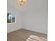 Empty bedroom with natural light, wood flooring, and a modern lighting fixture at 3025 Ivanhoe St, Denver, CO 80207