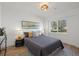 Bright bedroom featuring a large window, modern lighting fixture, and stylish decor with a gray bedspread at 3025 Ivanhoe St, Denver, CO 80207