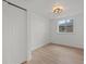 Bright bedroom features a closet, window, modern lighting fixture, and wood flooring at 3025 Ivanhoe St, Denver, CO 80207