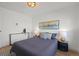 Bright bedroom featuring a large window, modern lighting fixture, and stylish decor with a gray bedspread at 3025 Ivanhoe St, Denver, CO 80207