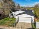 Exterior shot of the home, displaying the garage and fenced yard at 3025 Ivanhoe St, Denver, CO 80207