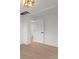 Hallway featuring a modern lighting fixture, and wood flooring at 3025 Ivanhoe St, Denver, CO 80207