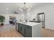 Modern kitchen with a spacious island, sleek appliances, and an adjacent dining area at 3025 Ivanhoe St, Denver, CO 80207