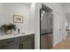 Stylish kitchen nook featuring a modern fridge, white walls, and a sink with an adjacent serving area at 3025 Ivanhoe St, Denver, CO 80207