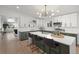 Gorgeous kitchen with a large island, bar stool seating, stainless appliances, and bright lighting at 3025 Ivanhoe St, Denver, CO 80207