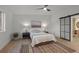 Comfortable main bedroom featuring a ceiling fan, barn door to ensuite bathroom, and stylish rug at 3025 Ivanhoe St, Denver, CO 80207
