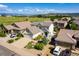 Aerial view of a suburban community with a home featuring lush landscaping and mountain views at 3841 Colorful Ln, Castle Rock, CO 80109