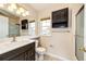 Bathroom with dark wood cabinets, a large mirror and a shower with glass doors at 3841 Colorful Ln, Castle Rock, CO 80109