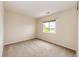Carpeted bedroom featuring natural light from the window and neutral walls at 3841 Colorful Ln, Castle Rock, CO 80109