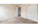 Clean bedroom featuring neutral walls, carpeted floors, and a closet with doors at 3841 Colorful Ln, Castle Rock, CO 80109