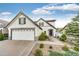 Charming two-story home featuring a well-manicured lawn, mature landscaping and a two car garage at 3841 Colorful Ln, Castle Rock, CO 80109