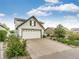 Charming two-story home featuring a well-manicured lawn, mature landscaping and a two car garage at 3841 Colorful Ln, Castle Rock, CO 80109