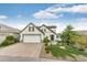 Charming two-story home featuring a well-manicured lawn, mature landscaping and a two car garage at 3841 Colorful Ln, Castle Rock, CO 80109