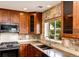 The kitchen features stainless steel appliances, stone backsplash, and a window over the sink at 3841 Colorful Ln, Castle Rock, CO 80109