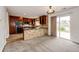 An open floor plan integrates the kitchen with stone accents, dark wood cabinets, and sliding doors at 3841 Colorful Ln, Castle Rock, CO 80109