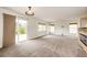 A living room features neutral walls, carpet, and a sliding door leading to the patio at 3841 Colorful Ln, Castle Rock, CO 80109