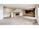 Living room view featuring stone fireplace, access to the kitchen, and a staircase at 3841 Colorful Ln, Castle Rock, CO 80109