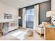Bedroom featuring neutral tones, large windows, a crib, and a cozy reading nook at 13763 Daffodil Way, Parker, CO 80134