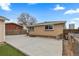 Backyard with a concrete patio, chicken coop, and detached garage at 1996 S Dexter St, Denver, CO 80222