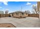 Home's exterior with brick, expansive concrete patio, and fenced yard at 1996 S Dexter St, Denver, CO 80222