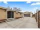 Home's backyard with detached garage and sliding glass door to inside at 1996 S Dexter St, Denver, CO 80222
