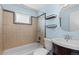Bathroom with bath and shower combination featuring nice tile work and shelving at 1996 S Dexter St, Denver, CO 80222