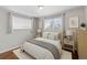 Bright bedroom with two windows, neutral décor, and a comfortable bed, perfect for relaxation at 1996 S Dexter St, Denver, CO 80222