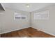 This bedroom features hardwood floors, two windows for natural light and neutral paint at 1996 S Dexter St, Denver, CO 80222