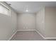 Finished basement bedroom with neutral walls and carpet, and a window for natural light at 1996 S Dexter St, Denver, CO 80222
