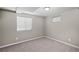 Finished basement bedroom with neutral walls and carpet, and a pair of windows for light at 1996 S Dexter St, Denver, CO 80222