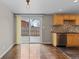 This dining area has wood floors, a sliding glass door to the backyard and a small kitchen at 1996 S Dexter St, Denver, CO 80222