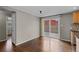 Open dining space with wood floors, slider to the backyard, and access to kitchen and hallway at 1996 S Dexter St, Denver, CO 80222