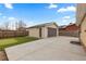 View of the backyard with the detached garage and a putting green at 1996 S Dexter St, Denver, CO 80222