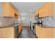 Well-lit kitchen features stainless steel appliances, tile backsplash, and ample counter space at 1996 S Dexter St, Denver, CO 80222