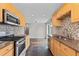 Well-lit kitchen features stainless steel appliances, tile backsplash, gas range, and ample cabinet space at 1996 S Dexter St, Denver, CO 80222