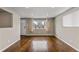 Spacious living room with gleaming hardwood floors, neutral paint, large windows, and recessed lighting at 1996 S Dexter St, Denver, CO 80222