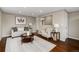 Bright living room features hardwood floors, neutral paint, a sofa, arm chair, coffee table, and recessed lighting at 1996 S Dexter St, Denver, CO 80222
