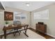 This office has a minimalist desk and a cabinet with two windows bringing in plenty of light at 1996 S Dexter St, Denver, CO 80222