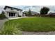 A well-maintained backyard featuring a spacious lawn, privacy fence and mature trees at 3029 Merlin Dr, Brighton, CO 80601