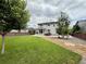 The spacious backyard features a well-manicured lawn and patio area for outdoor living at 3029 Merlin Dr, Brighton, CO 80601