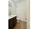 Bright bathroom featuring a vanity, toilet, and shower with modern fixtures at 3029 Merlin Dr, Brighton, CO 80601