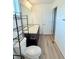 Bathroom featuring a single sink vanity, tile floor, and modern shelving at 3029 Merlin Dr, Brighton, CO 80601