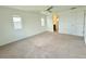 Expansive bedroom with neutral carpeting, two windows, and a ceiling fan at 3029 Merlin Dr, Brighton, CO 80601