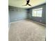 Bedroom featuring a modern ceiling fan, carpet flooring, and ample natural light at 3029 Merlin Dr, Brighton, CO 80601